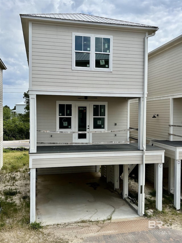 rear view of house featuring french doors and metal roof
