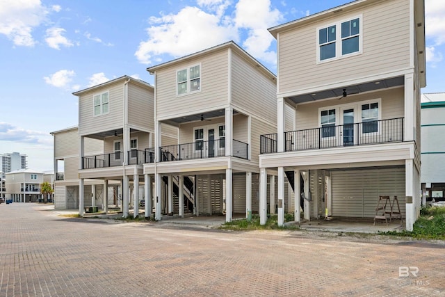 rear view of property with stairway, french doors, and ceiling fan