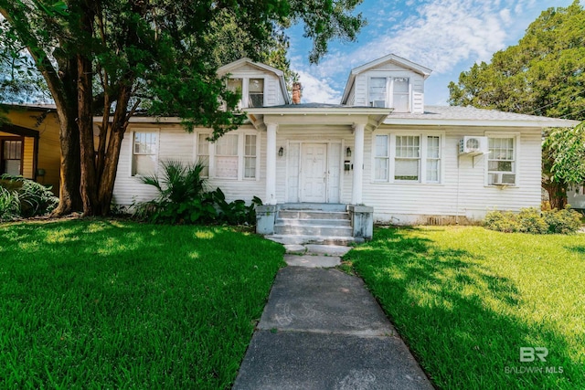 view of front of house with cooling unit and a front yard