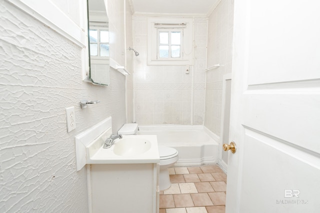 full bathroom with toilet, tiled shower / bath, tile patterned floors, and vanity