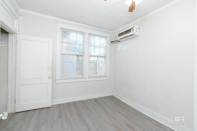 empty room featuring light hardwood / wood-style floors, an AC wall unit, crown molding, and ceiling fan