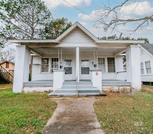 bungalow-style house featuring a front lawn and a porch