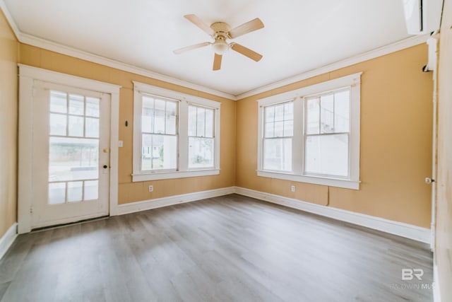 spare room with ceiling fan, light hardwood / wood-style floors, a wealth of natural light, and ornamental molding