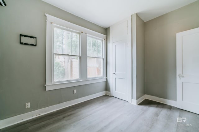 unfurnished bedroom with light wood-type flooring