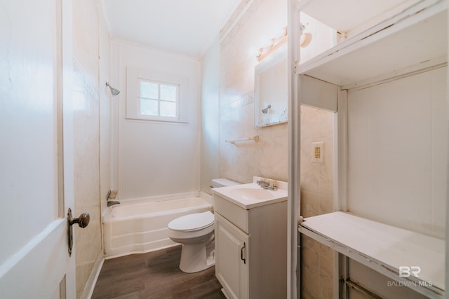 full bathroom with vanity, toilet, hardwood / wood-style flooring, crown molding, and  shower combination