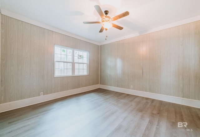 empty room with ceiling fan and hardwood / wood-style flooring