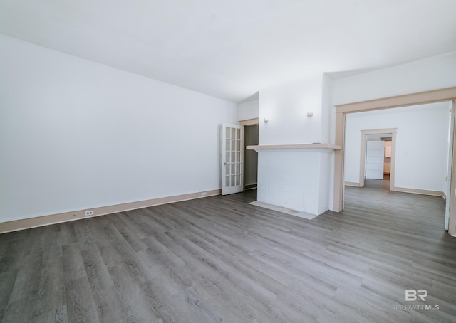 unfurnished living room with hardwood / wood-style flooring