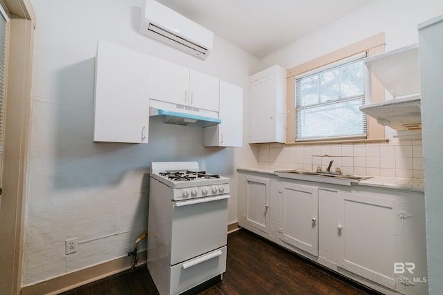 kitchen featuring sink, white cabinetry, white range with gas cooktop, and a wall mounted air conditioner