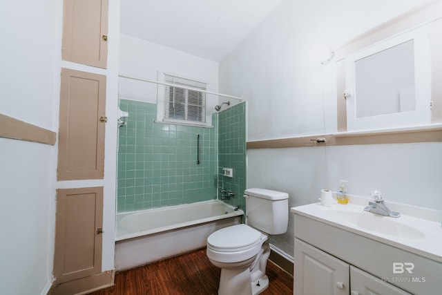 full bathroom featuring toilet, tiled shower / bath, hardwood / wood-style flooring, and vanity