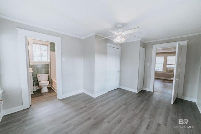 spare room featuring ceiling fan, cooling unit, crown molding, and hardwood / wood-style flooring