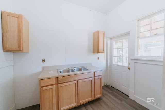 kitchen with sink, light brown cabinets, and light hardwood / wood-style flooring