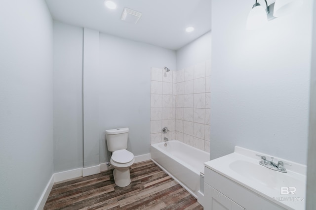 full bathroom with wood-type flooring, toilet, vanity, and tiled shower / bath