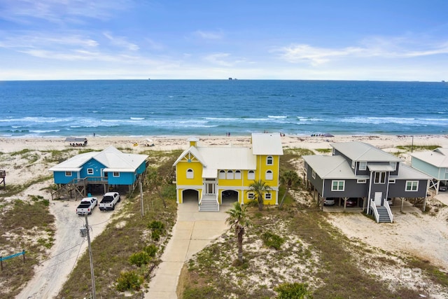 drone / aerial view featuring a view of the beach and a water view