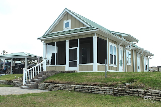 view of side of home featuring a sunroom