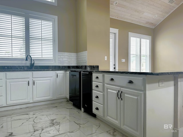 kitchen with white cabinetry, wooden ceiling, kitchen peninsula, and vaulted ceiling