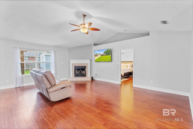 27913 Turkey Branch Dr, Daphne, AL 36526 - living room with a ceiling fan, wood finished floors, vaulted ceiling, and a tile fireplace