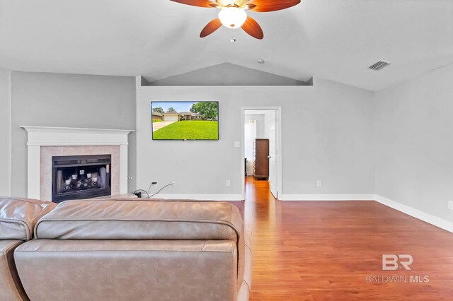 27913 Turkey Branch Dr, Daphne, AL 36526 - living room featuring a ceiling fan, wood finished floors, lofted ceiling, and a tiled fireplace