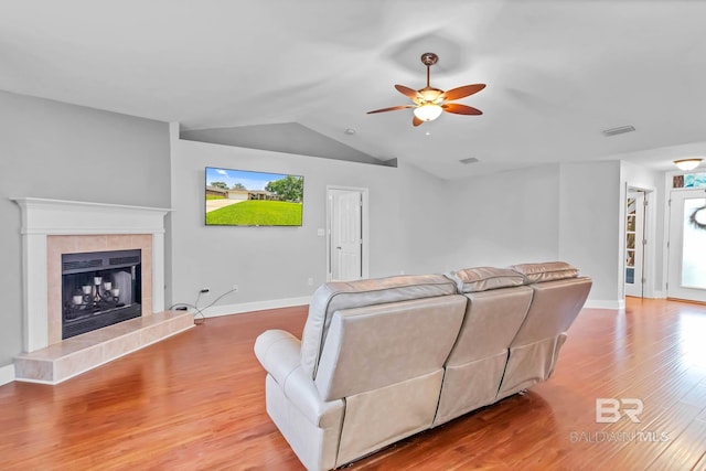 27913 Turkey Branch Dr, Daphne, AL 36526 - living room featuring ceiling fan, light wood-type flooring, vaulted ceiling, and a tile fireplace