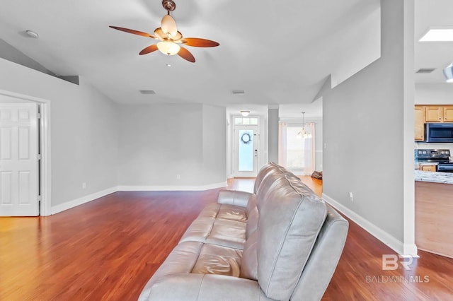 27913 Turkey Branch Dr, Daphne, AL 36526 - living room with ceiling fan, wood finished floors, vaulted ceiling, and a chandelier