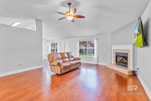 27913 Turkey Branch Dr, Daphne, AL 36526 - living room with a ceiling fan, a fireplace with raised hearth, lofted ceiling, and wood finished floors
