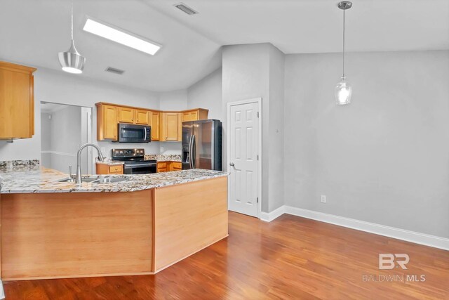27913 Turkey Branch Dr, Daphne, AL 36526 - kitchen with stainless steel refrigerator with ice dispenser, range with electric stovetop, a peninsula, light stone counters, and wood finished floors