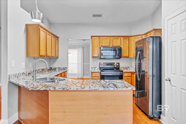 27913 Turkey Branch Dr, Daphne, AL 36526 - kitchen with stainless steel appliances, a peninsula, light stone countertops, and light wood-style flooring