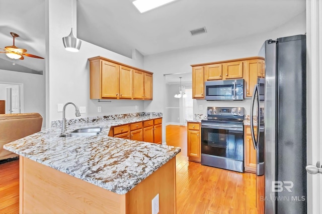 27913 Turkey Branch Dr, Daphne, AL 36526 - kitchen with stainless steel appliances, a peninsula, light wood finished floors, and ceiling fan