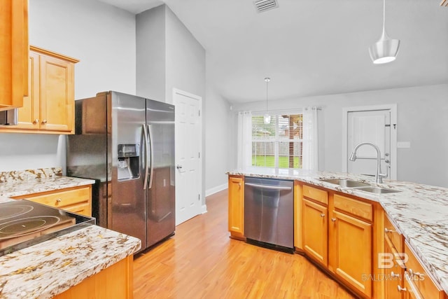 27913 Turkey Branch Dr, Daphne, AL 36526 - kitchen featuring stainless steel appliances, light wood-style floors, decorative light fixtures, vaulted ceiling, and light stone countertops