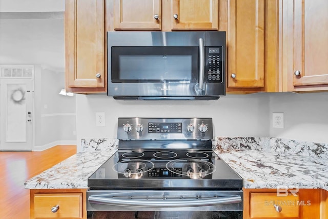27913 Turkey Branch Dr, Daphne, AL 36526 - kitchen featuring stainless steel appliances, wood finished floors, and light stone countertops