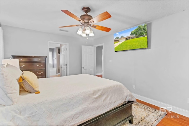27913 Turkey Branch Dr, Daphne, AL 36526 - bedroom with wood finished floors, ceiling fan, and ensuite bath