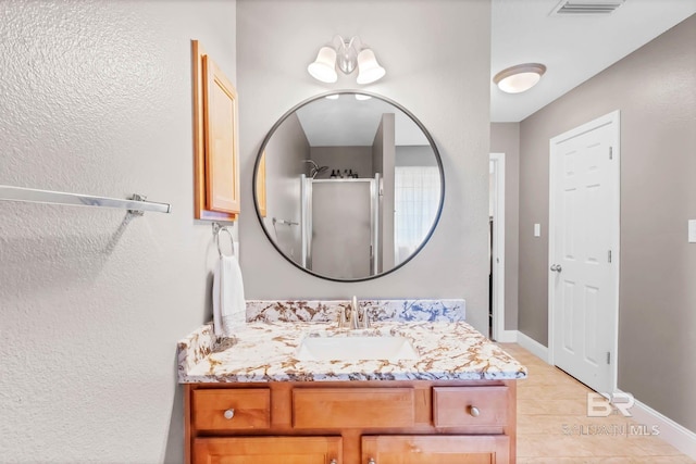 27913 Turkey Branch Dr, Daphne, AL 36526 - full bath with vanity, tile patterned floors, a textured wall, and a shower