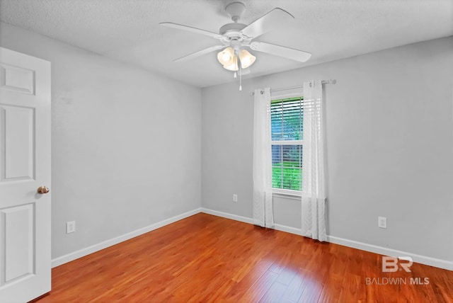 27913 Turkey Branch Dr, Daphne, AL 36526 - spare room with wood finished floors, a ceiling fan, and a textured ceiling