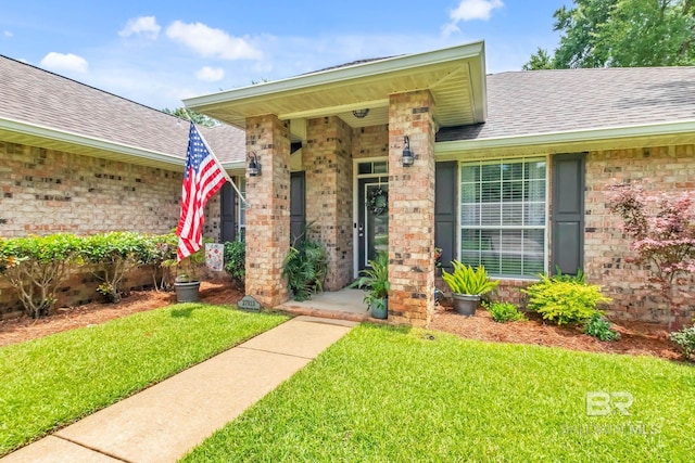 27913 Turkey Branch Dr, Daphne, AL 36526 - doorway to property featuring brick siding, a yard, and roof with shingles