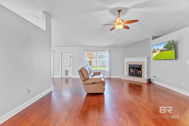 27913 Turkey Branch Dr, Daphne, AL 36526 - living area with a ceiling fan, lofted ceiling, a tile fireplace, and wood finished floors