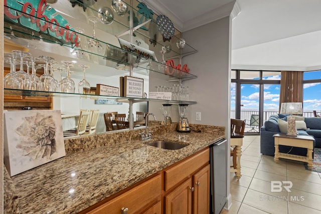 bar featuring indoor wet bar, crown molding, light tile patterned floors, expansive windows, and a sink