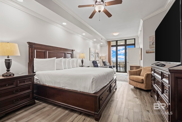 bedroom featuring light wood-style flooring, recessed lighting, access to outside, floor to ceiling windows, and crown molding