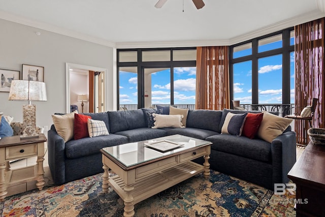 living room featuring ornamental molding and a ceiling fan