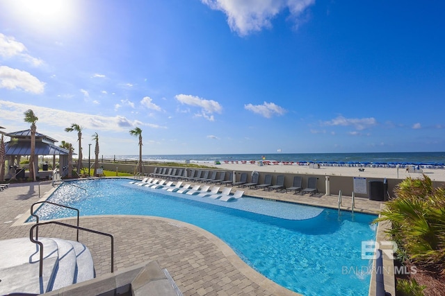 view of pool with a patio area, a gazebo, and a water view