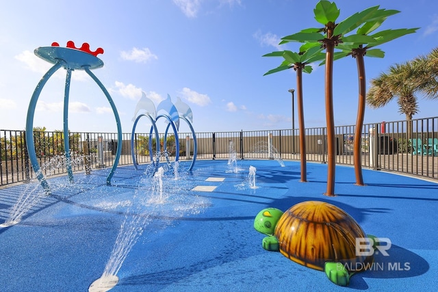 view of jungle gym featuring fence