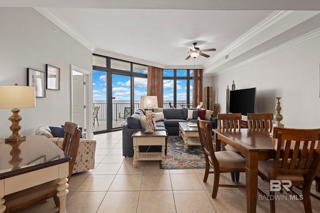 living room featuring floor to ceiling windows, crown molding, light tile patterned floors, visible vents, and ceiling fan