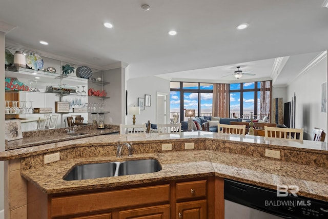 kitchen with ornamental molding, open floor plan, a sink, light stone countertops, and dishwasher