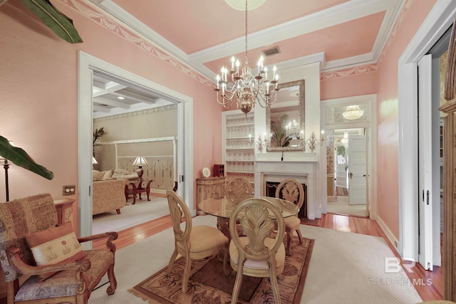 dining space with a notable chandelier, coffered ceiling, wood-type flooring, and ornamental molding