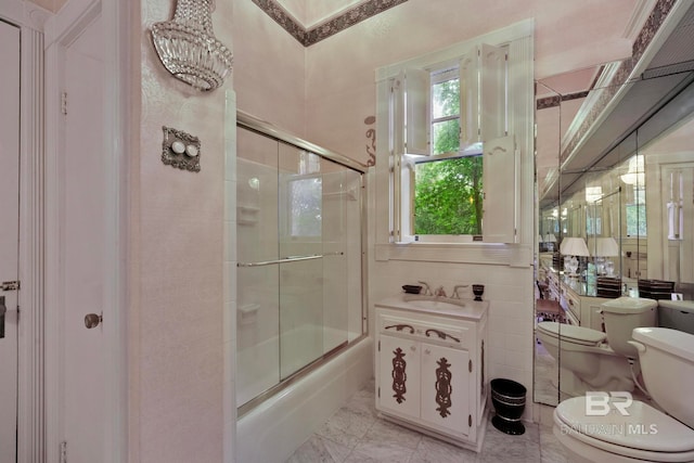 full bathroom featuring tile patterned floors, tile walls, bath / shower combo with glass door, and toilet