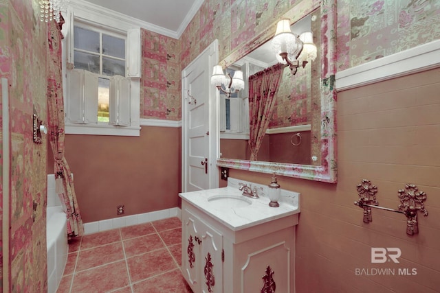 bathroom featuring tile patterned floors, ornamental molding, vanity, and a washtub