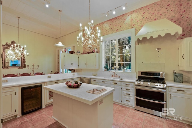 kitchen with range with two ovens, rail lighting, a notable chandelier, a center island, and wine cooler