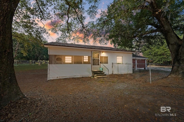view of front of property featuring entry steps and fence