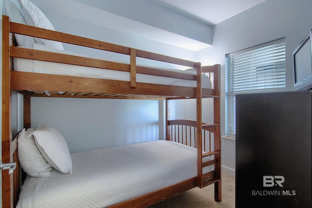 bedroom featuring multiple windows and carpet