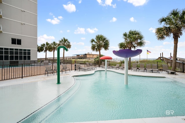 view of pool with a patio and pool water feature