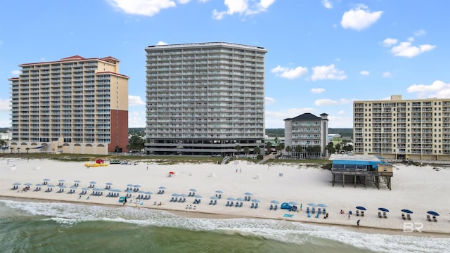 view of building exterior featuring a view of the beach and a water view