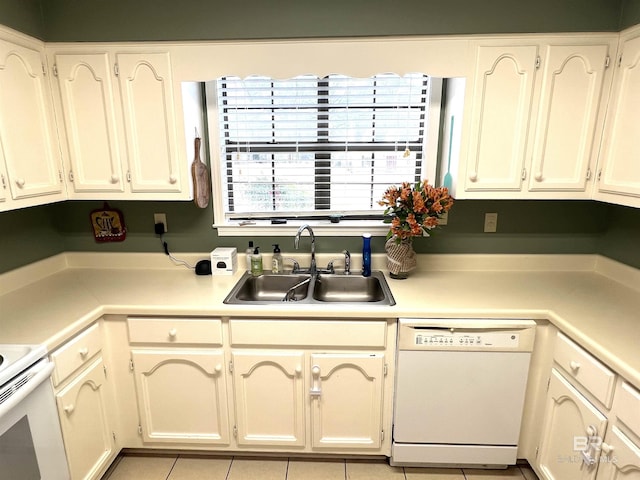 kitchen with sink, dishwasher, and light tile patterned floors